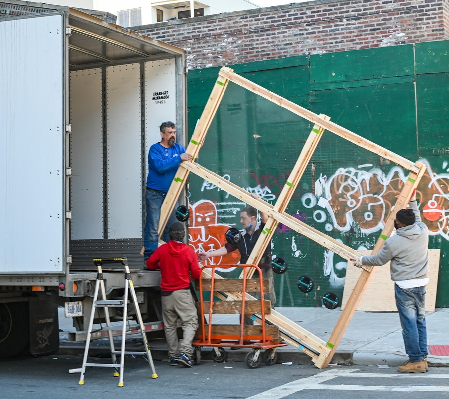 A Move Doctors crew carefully carrying a crated piece on an El Paso job
